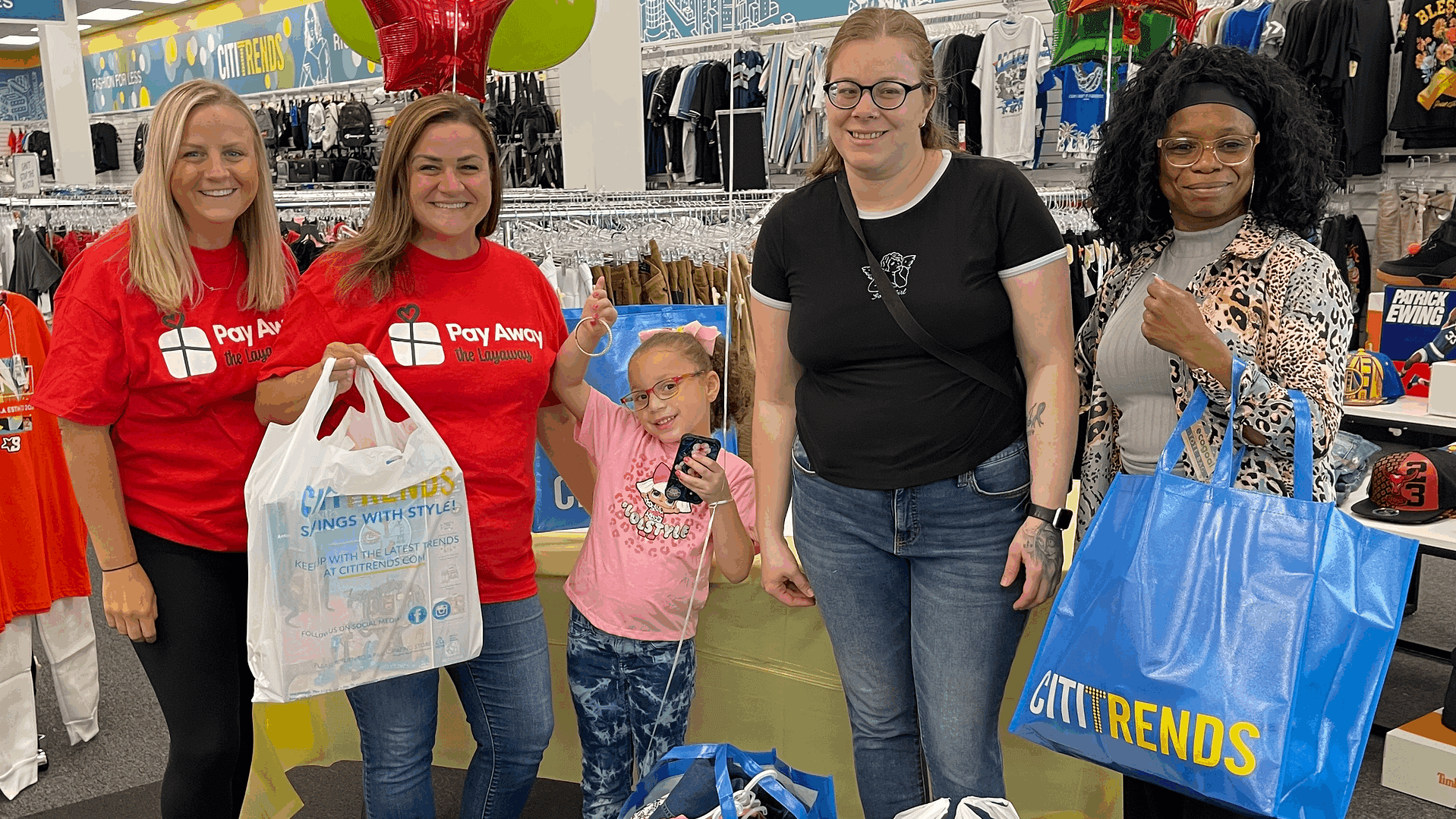Pay Away volunteers surprise mom and daughter with paid off layaway items.